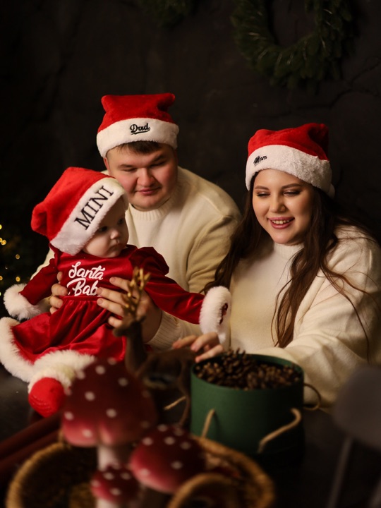 Parents with their baby wearing festive hats