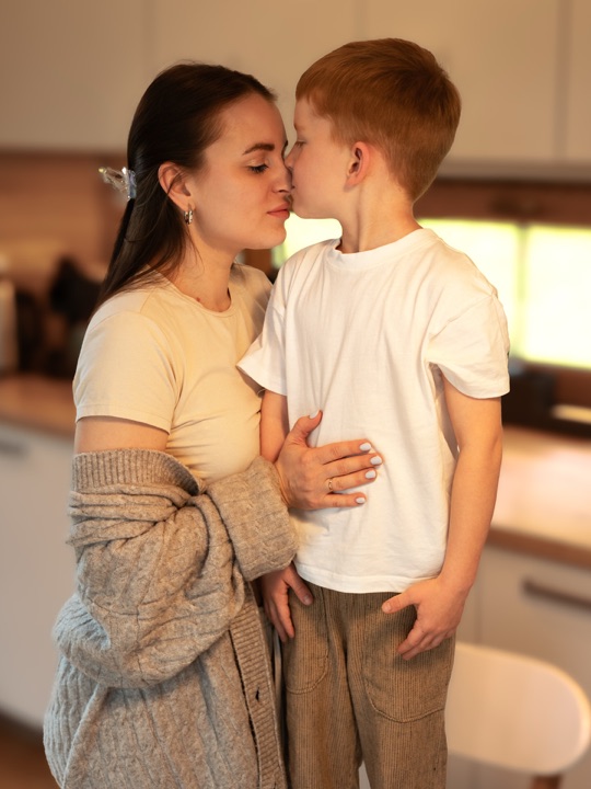 A mother and son touching noses