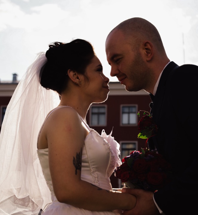 A wedding couple photographed in backlight