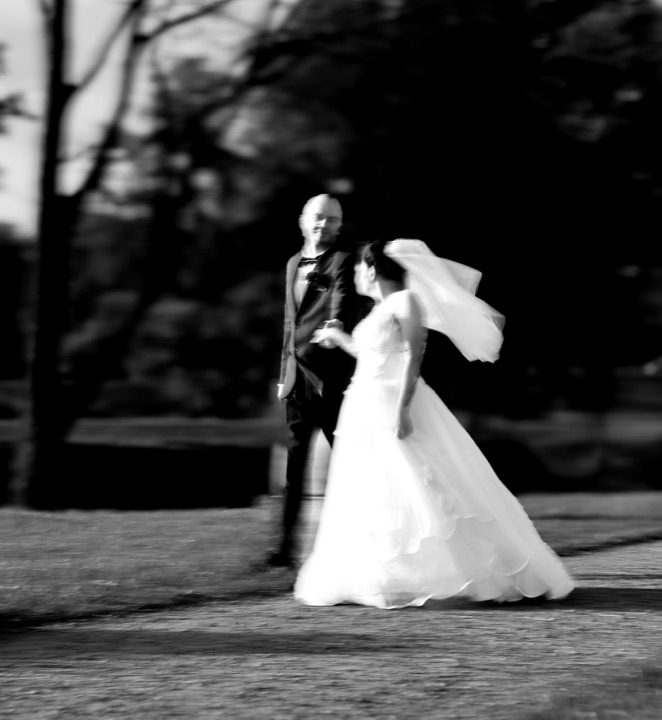 A black and white wedding photograph with motion blur
